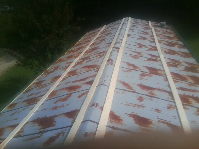 Rusted metal roof panels with new wood purlins before replacement — Storm Damage Roof Repair in Fort Recovery by Roofing Brothers